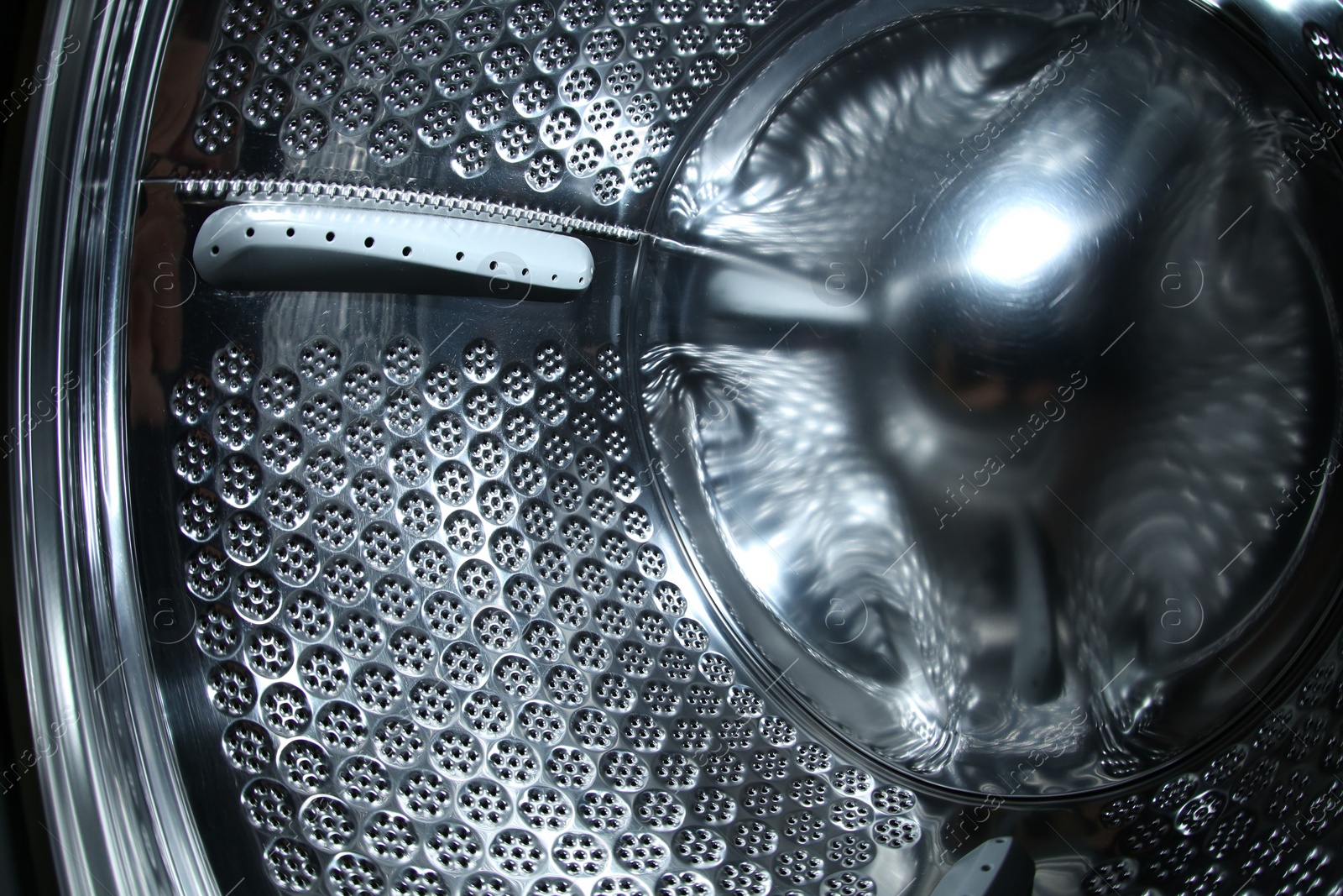 Photo of Empty washing machine drum, closeup view. Laundry day