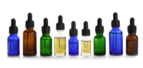 Photo of Different little bottles with essential oils on white background