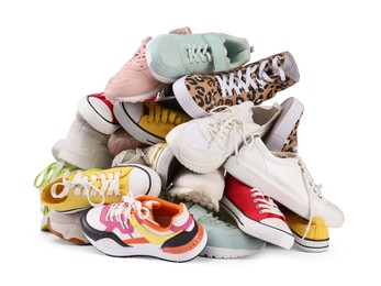 Pile of different female sneakers isolated on white