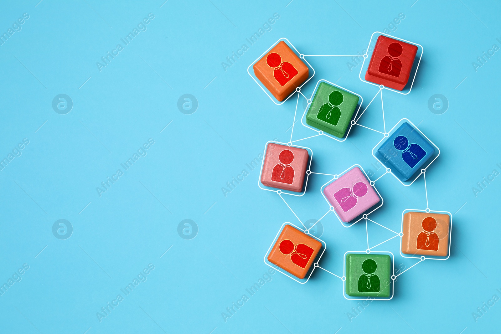 Image of Teamwork. Wooden cubes with human icons linked together symbolizing cooperation on light blue background, top view. Space for text