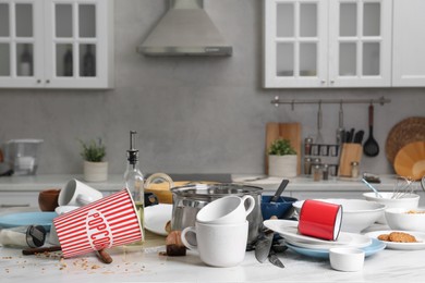 Photo of Many dirty utensils, dishware and food leftovers on white table. Mess in kitchen