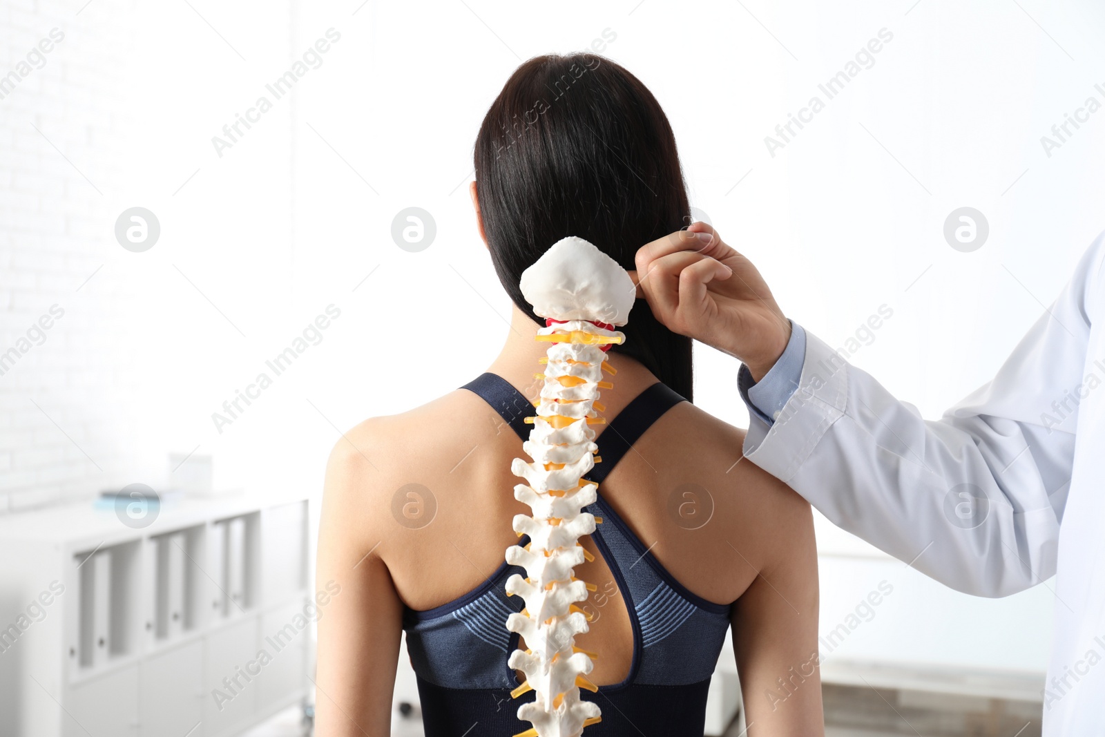 Photo of Young woman visiting orthopedist in medical office