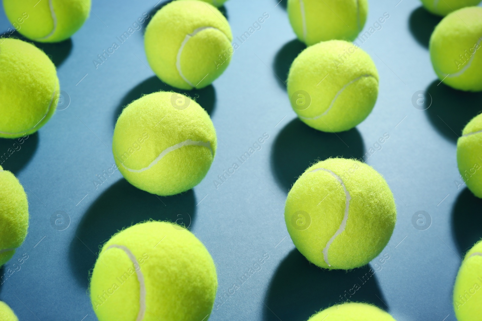 Photo of Tennis balls on blue background. Sports equipment