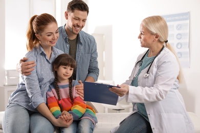 Family with child visiting doctor in hospital