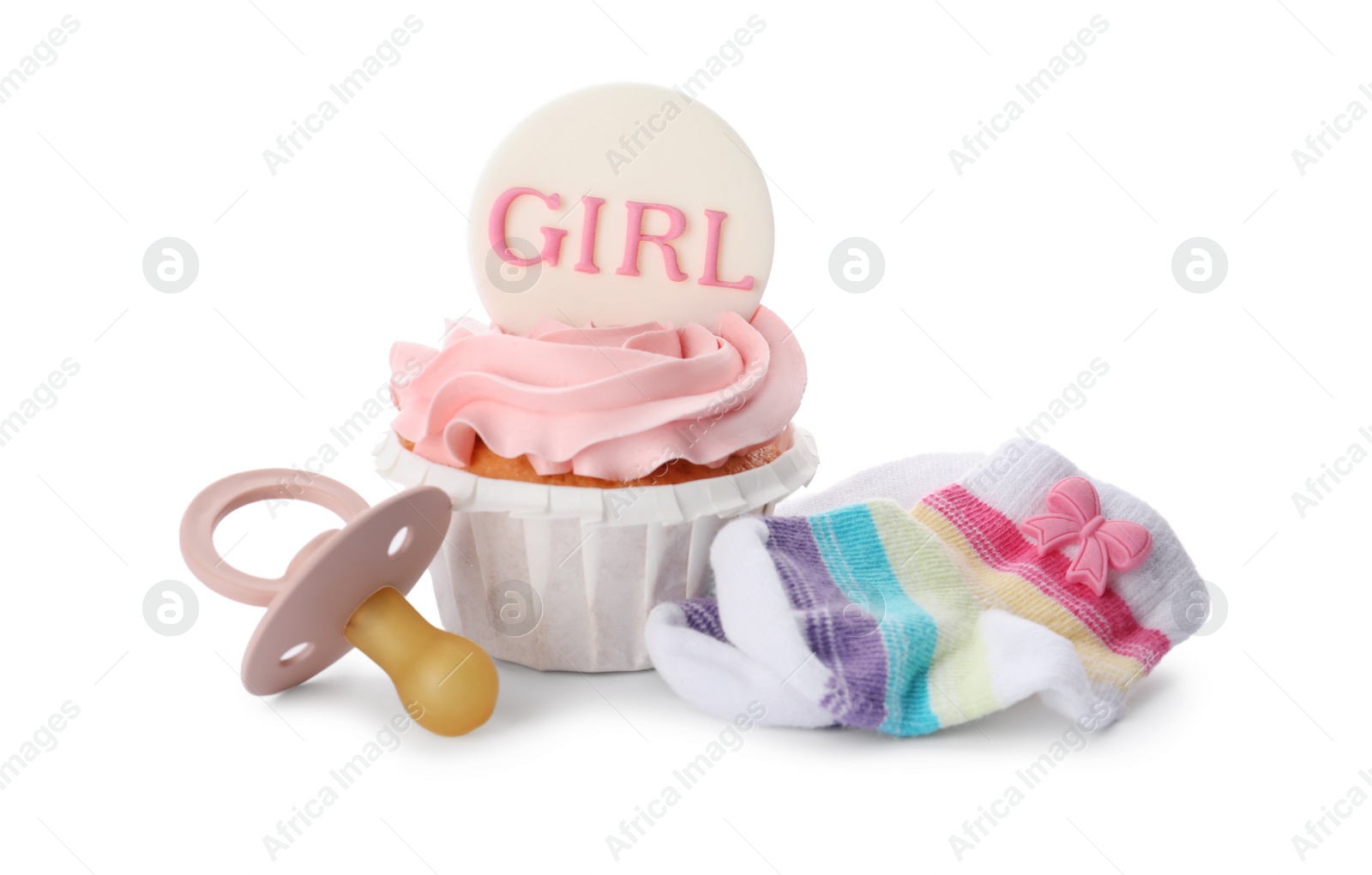 Photo of Baby shower cupcake with Girl topper near pacifier and socks on white background