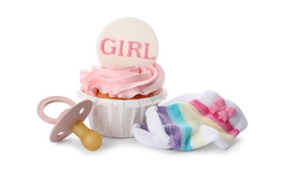 Photo of Baby shower cupcake with Girl topper near pacifier and socks on white background