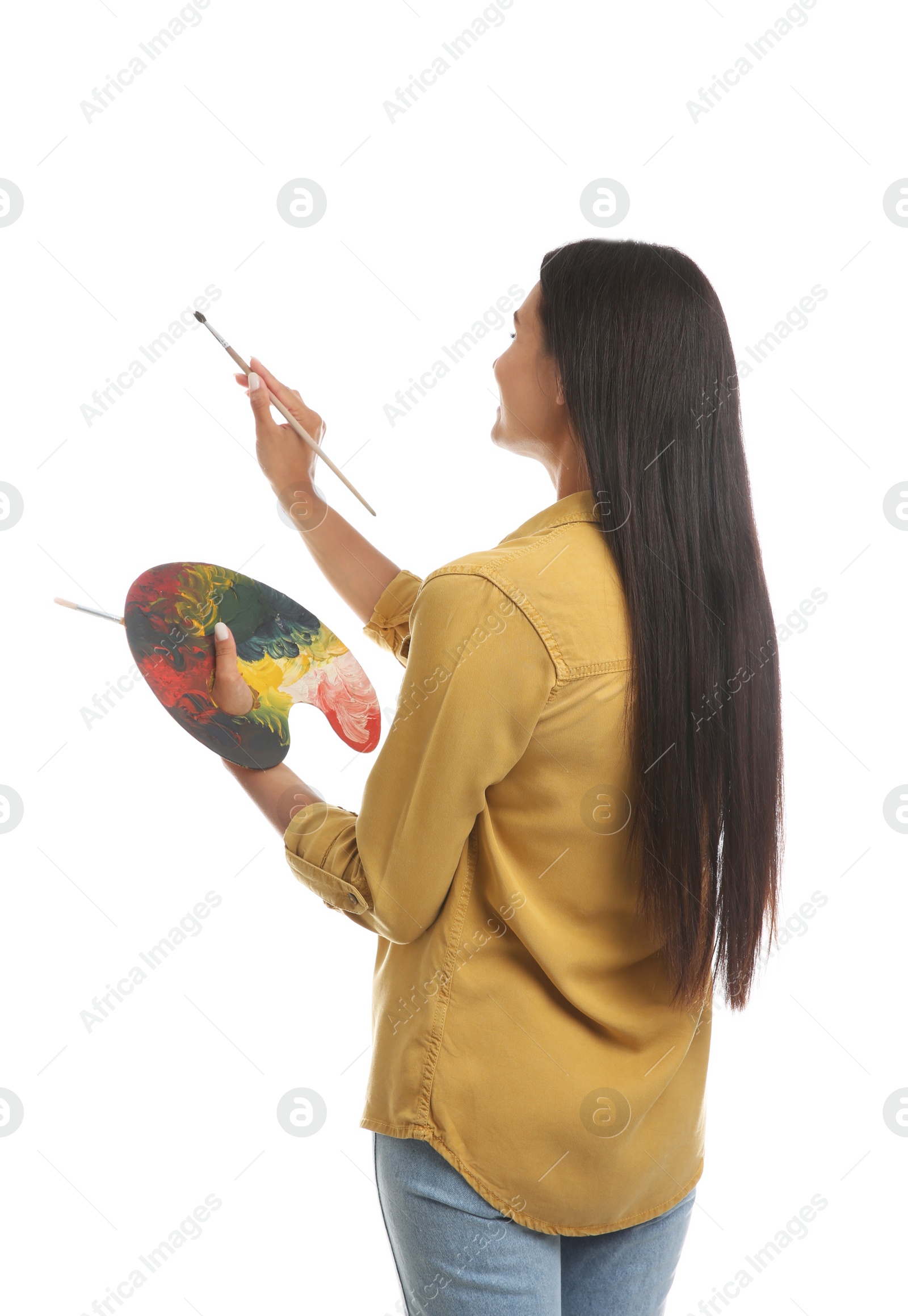 Photo of Young woman drawing with brush on white background, back view