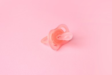 Photo of One new baby pacifier on pink background