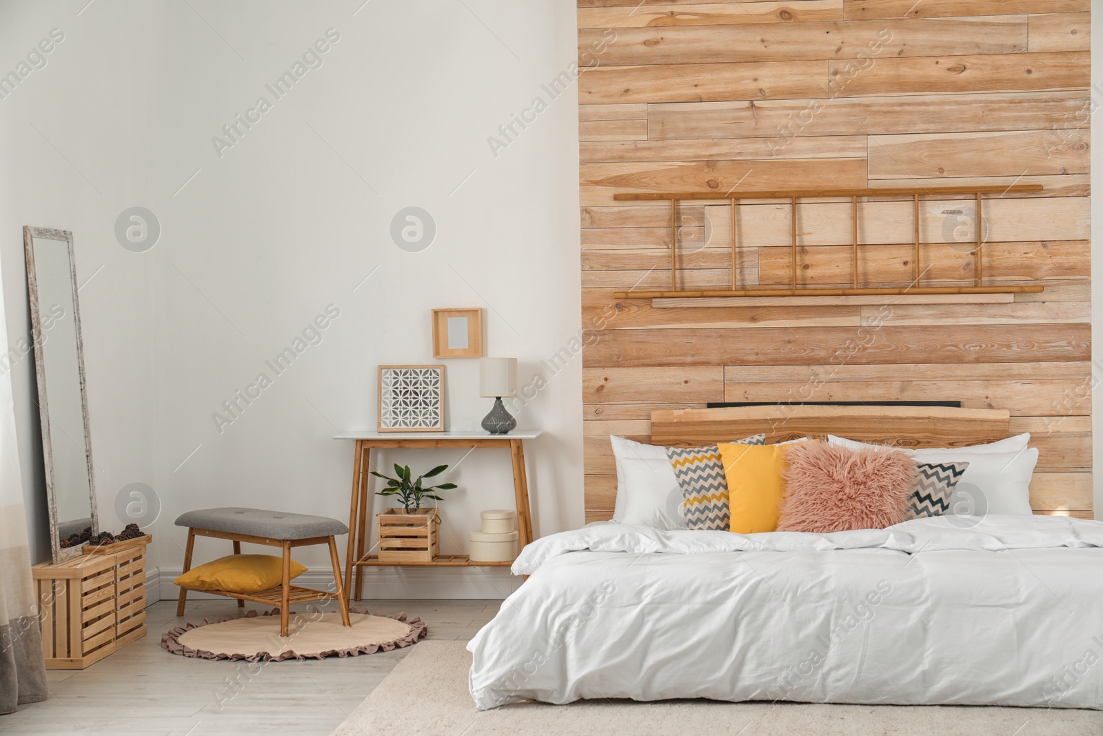 Photo of Stylish room interior with comfortable bed near wooden wall