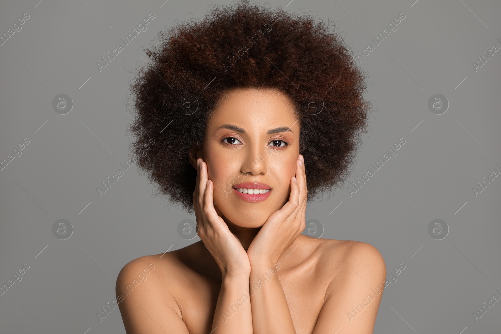 Photo of Portrait of beautiful young woman with glamorous makeup on grey background