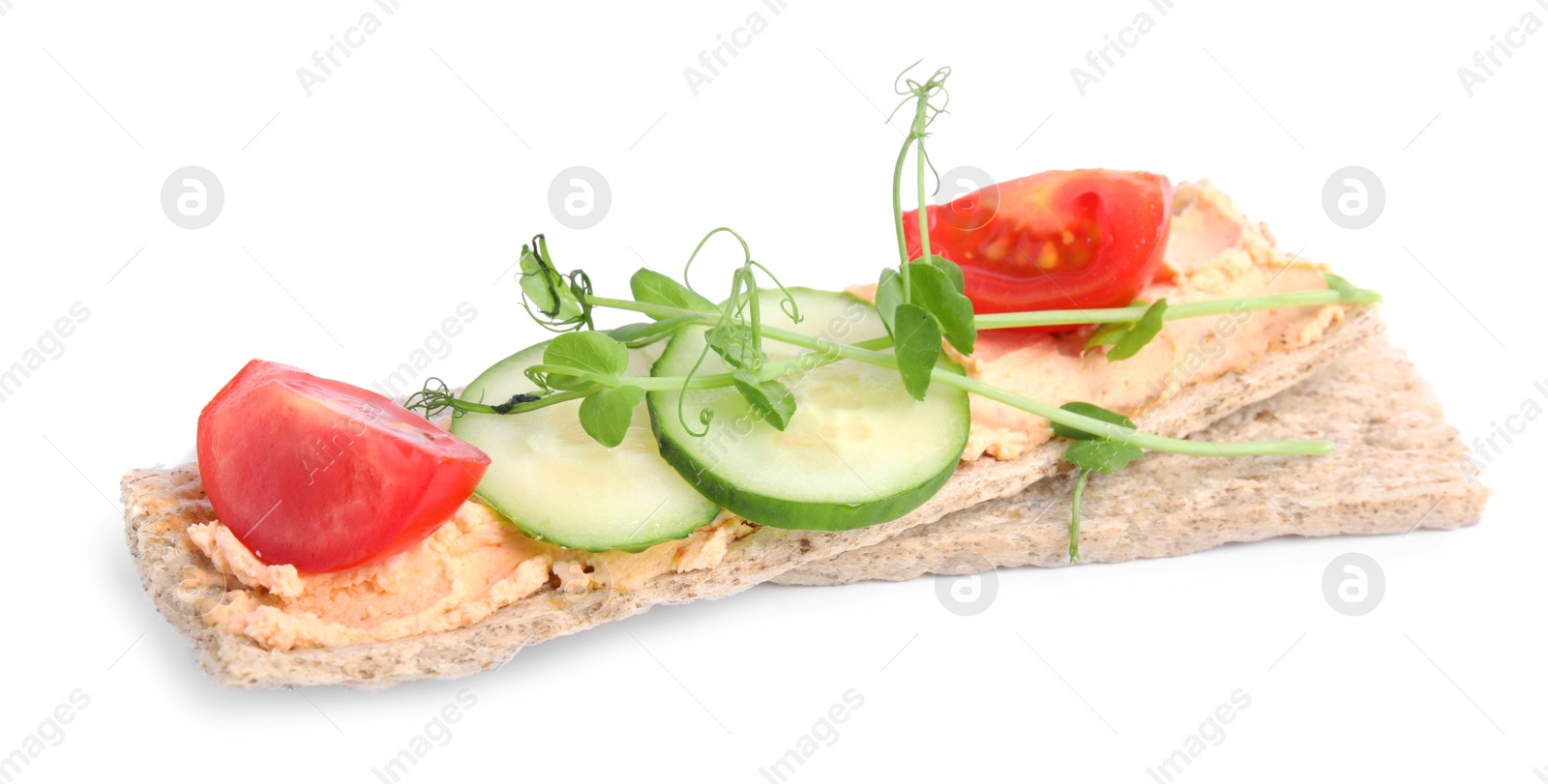 Photo of Tasty crispbreads with cream cheese and fresh vegetables isolated on white