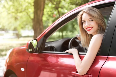 Young woman on driver's seat of car