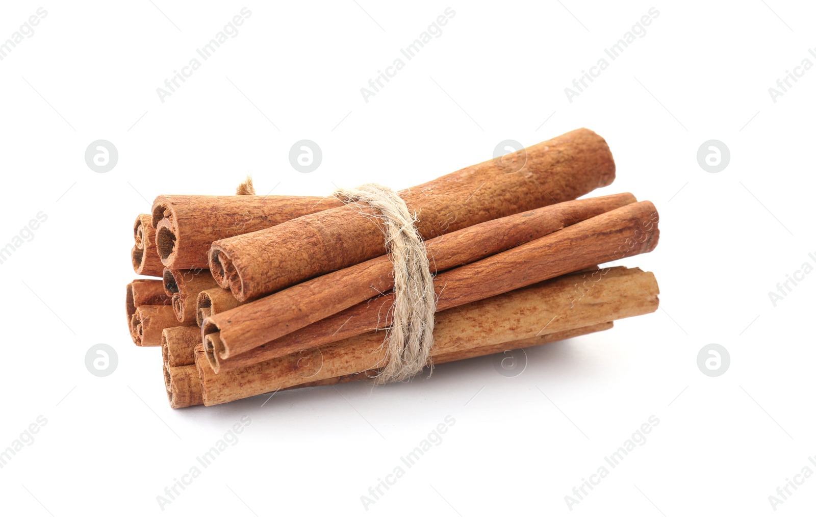 Photo of Tied cinnamon sticks on white background