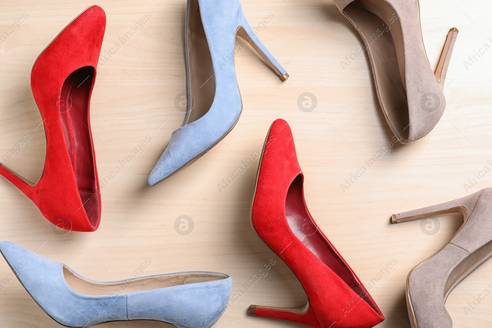 Photo of Flat lay composition of stylish lady's shoes on wooden background