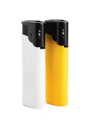 Stylish small pocket lighters on white background