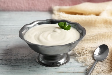 Bowl with yummy yogurt on table