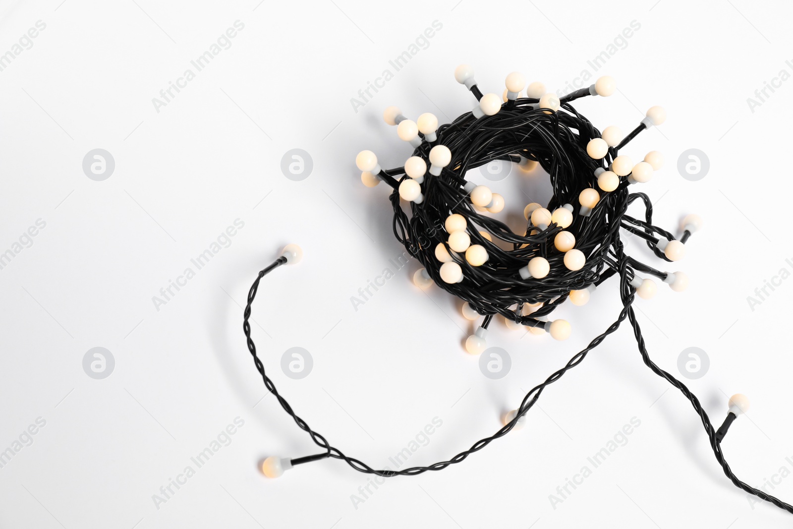 Photo of Bundle of beautiful Christmas lights on white background