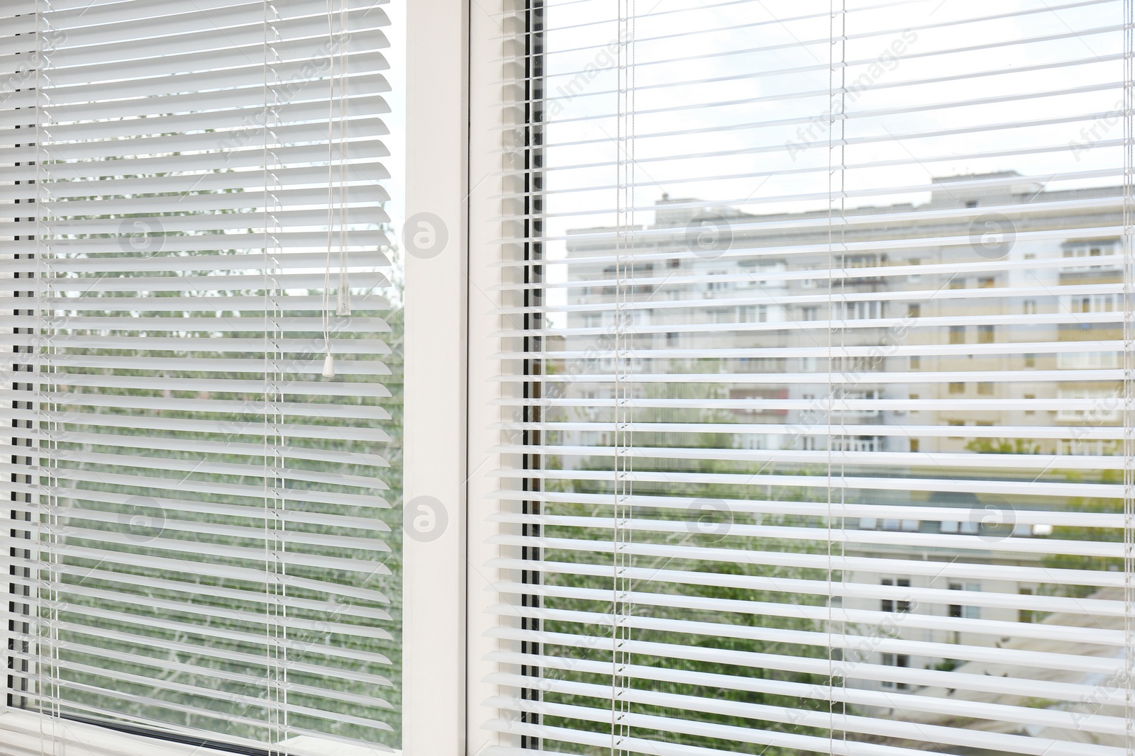 Photo of Window with open modern horizontal blinds indoors, closeup