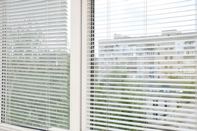 Window with open modern horizontal blinds indoors, closeup