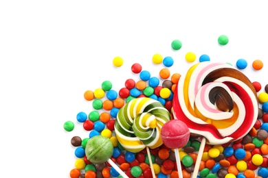 Photo of Lollipops and colorful candies on white background, top view