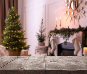 Image of Empty wooden surface and blurred view of room decorated for Christmas, space for text. Interior design