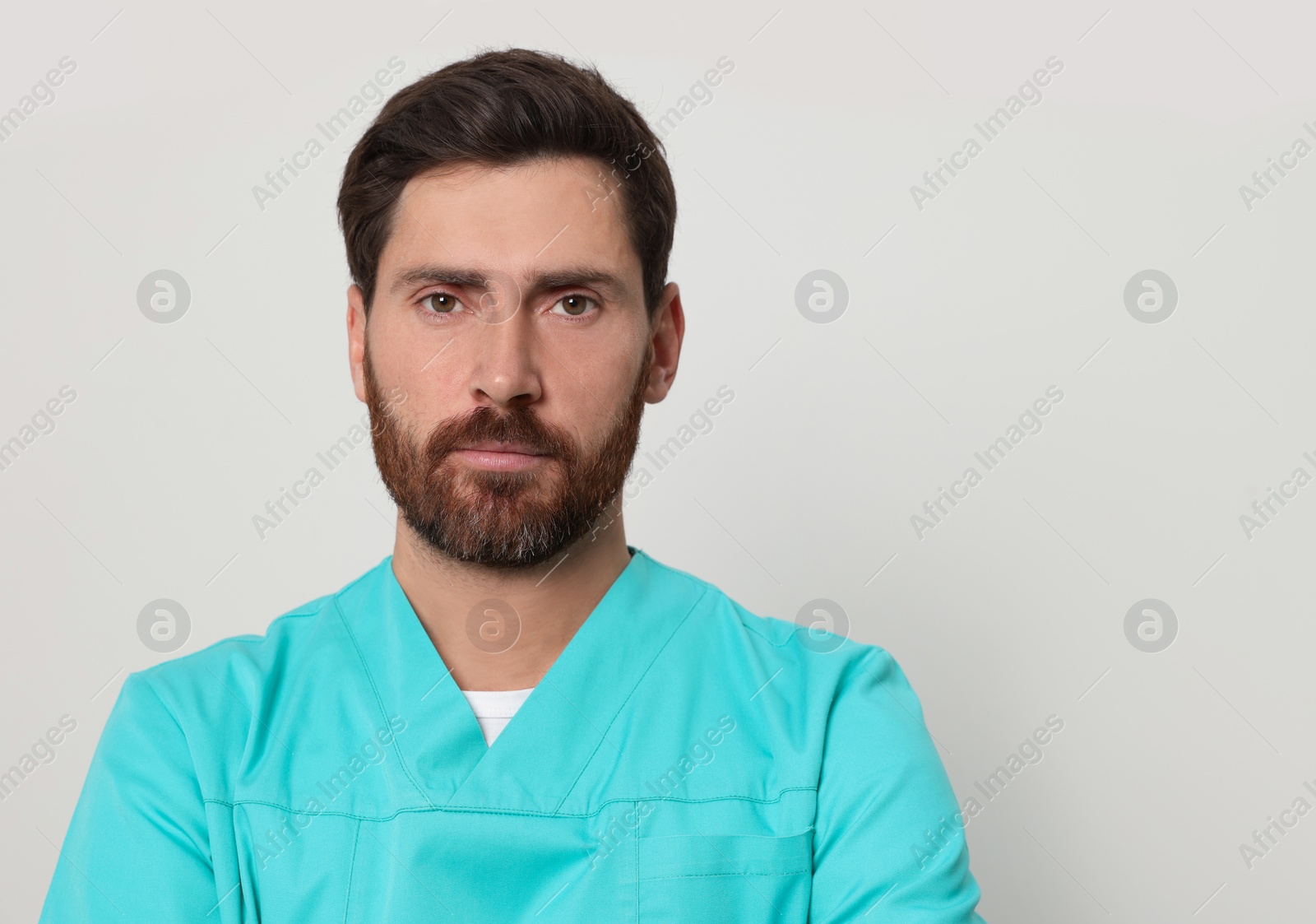 Photo of Nurse in medical uniform on white background