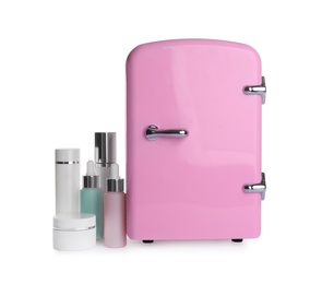 Pink cosmetics refrigerator and skin care products on white background