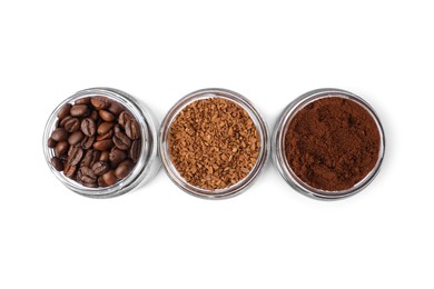 Jars with different types of coffee on white background, top view