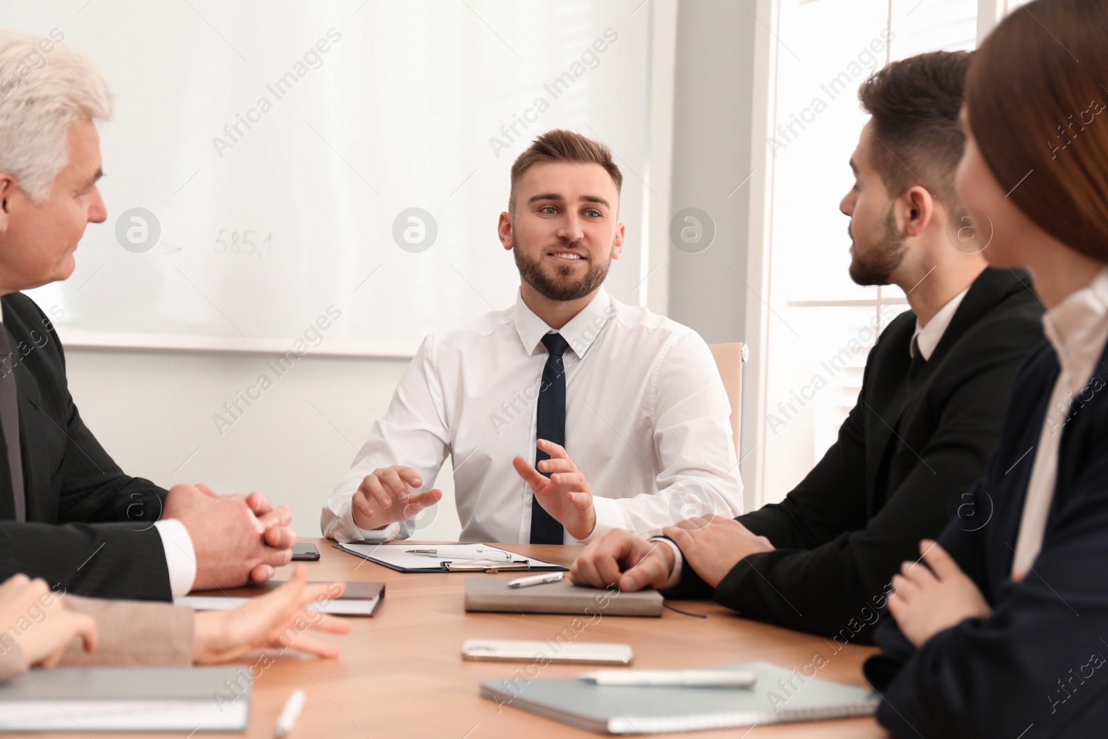 Photo of Professional business trainer working with people in office