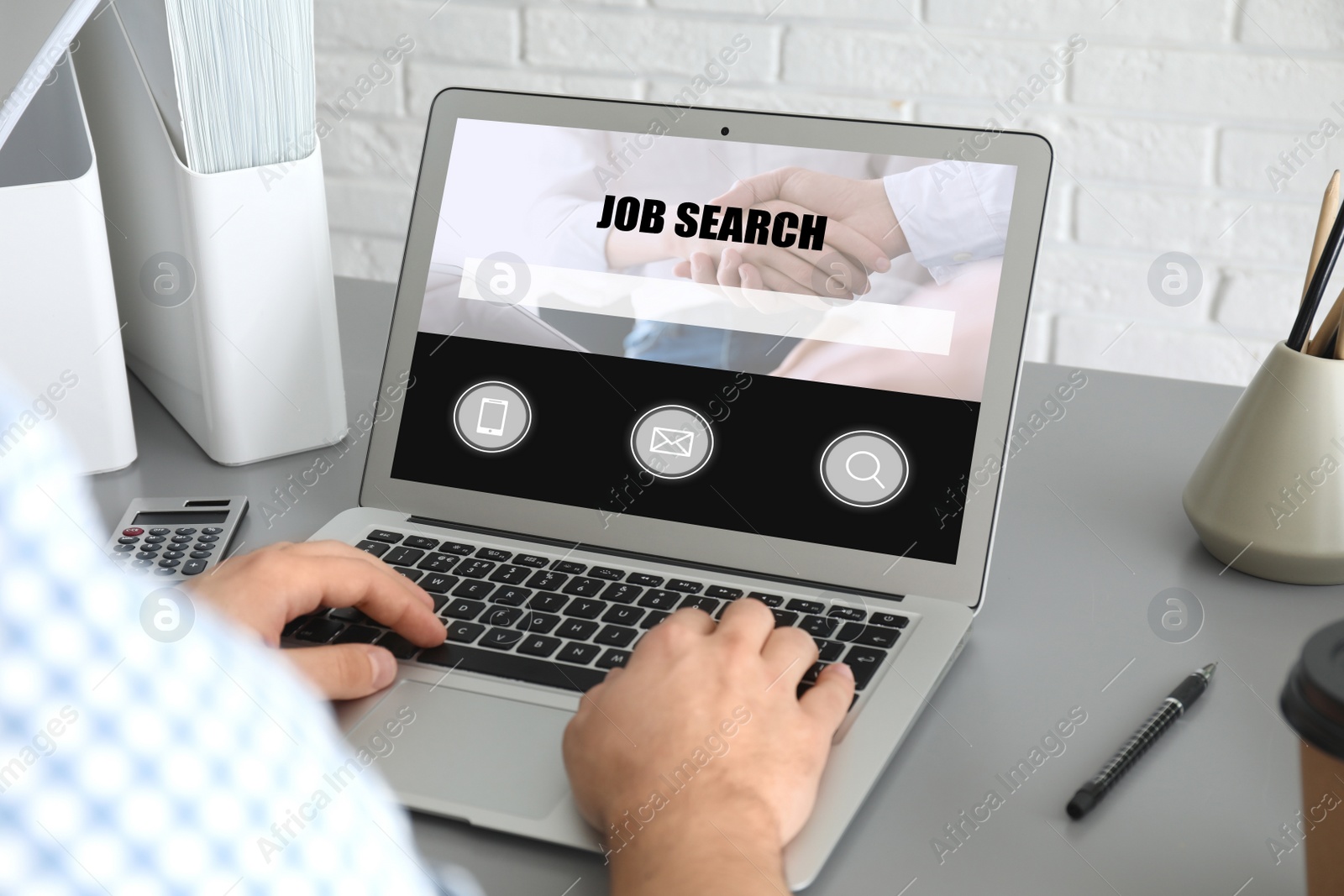 Image of Man searching job with laptop at table, closeup