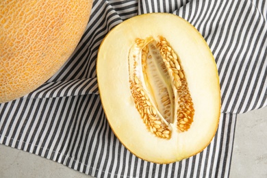 Photo of Tasty cut ripe melon on grey table, flat lay