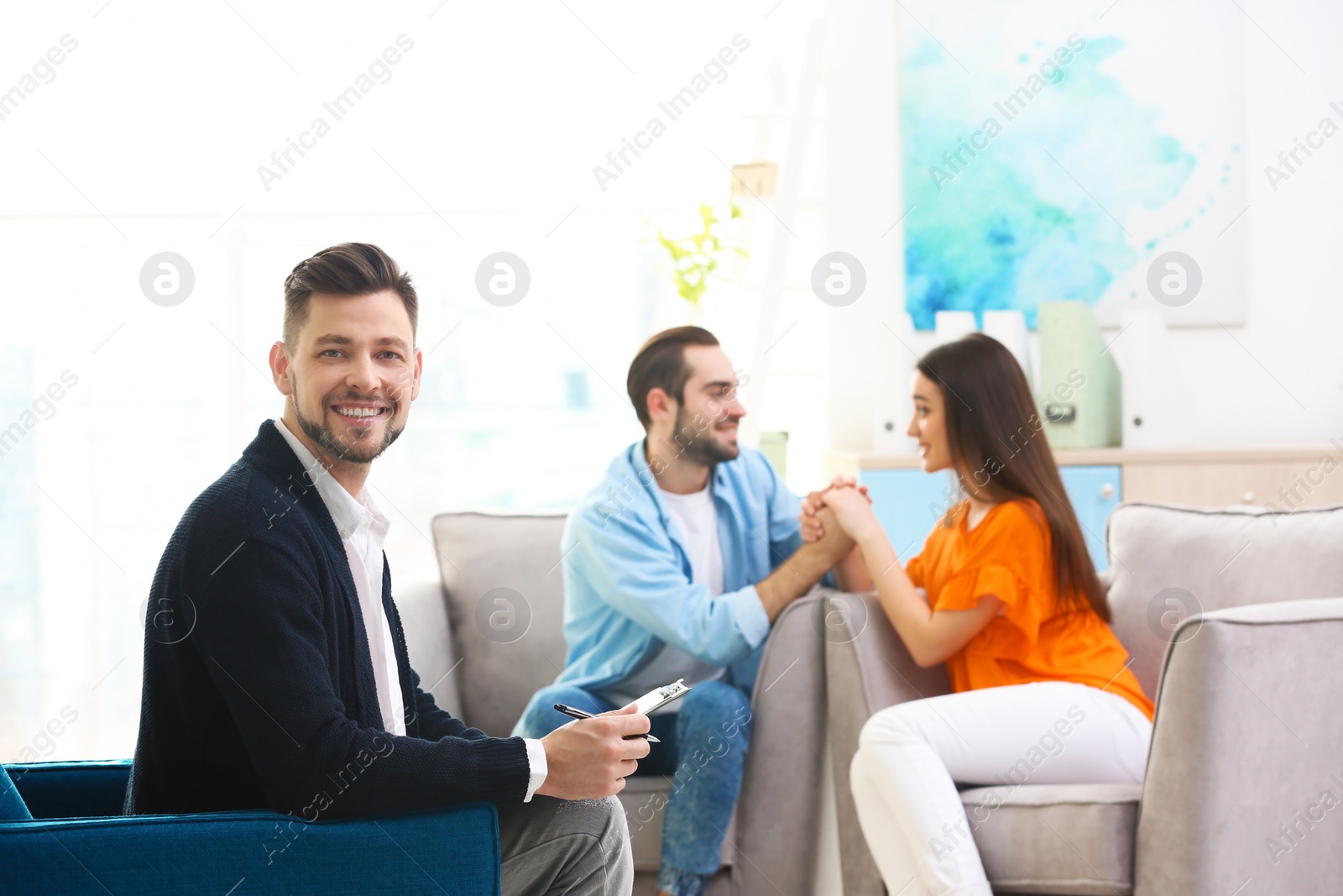 Photo of Professional psychologist and young couple in office