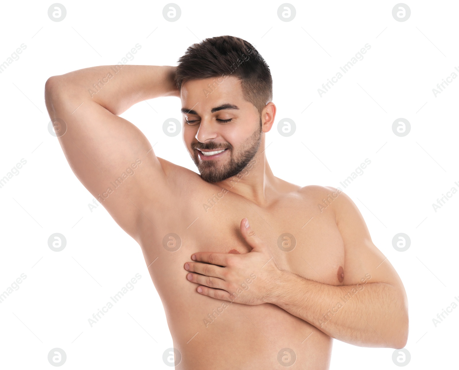 Photo of Young man showing hairless armpit after epilation procedure on white background