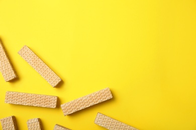 Photo of Flat lay composition with delicious crispy wafers on yellow background. Space for text