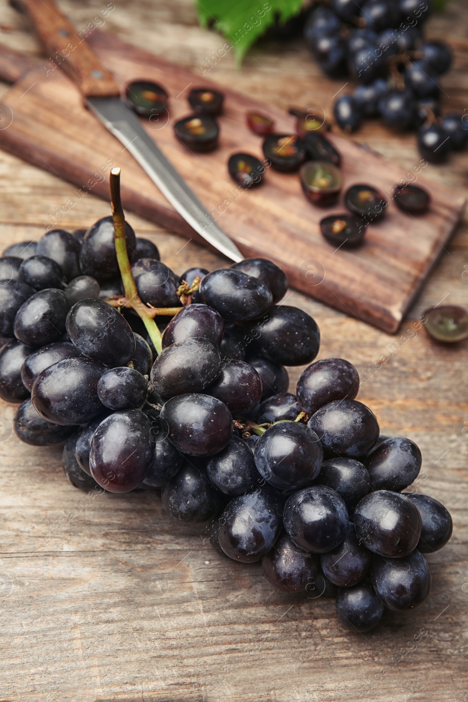 Photo of Fresh ripe juicy grapes on wooden table