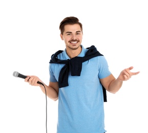 Photo of Young handsome man in casual clothes posing with microphone on white background