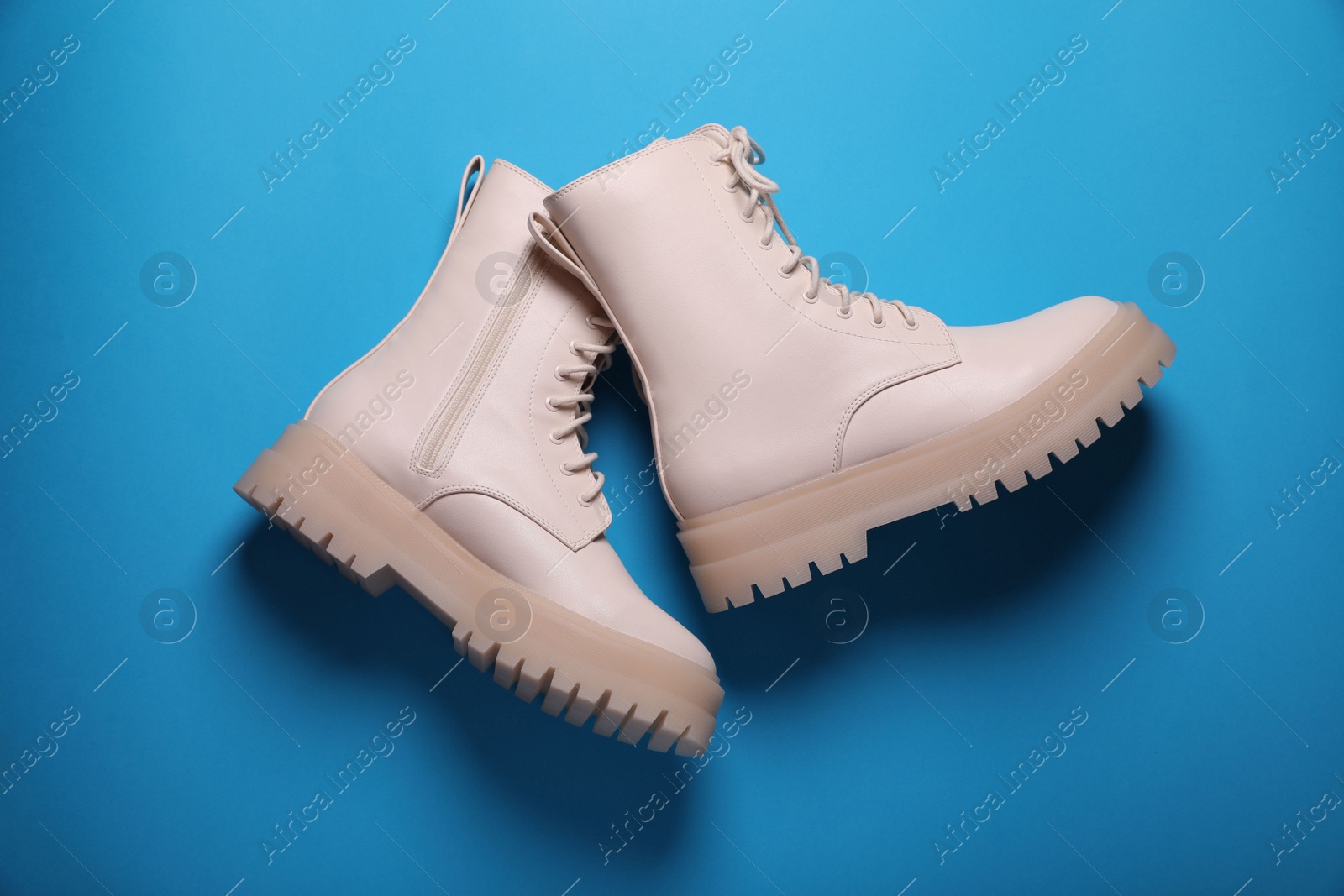 Photo of Pair of stylish leather shoes on light blue background, flat lay