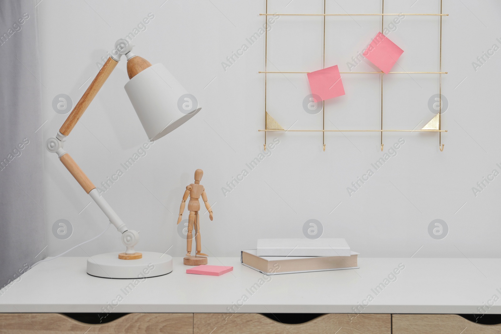 Photo of Desk lamp on table near white wall in room