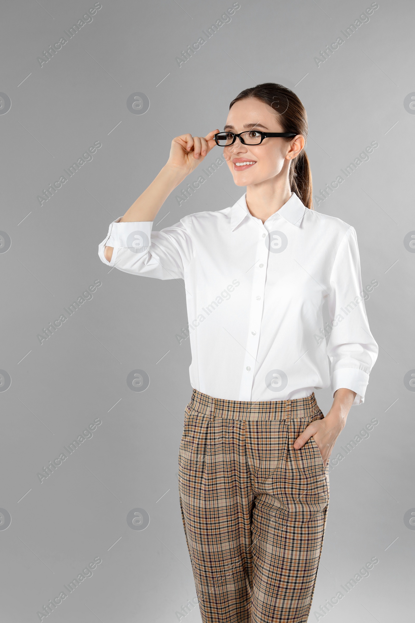 Photo of Portrait of young female teacher on grey background