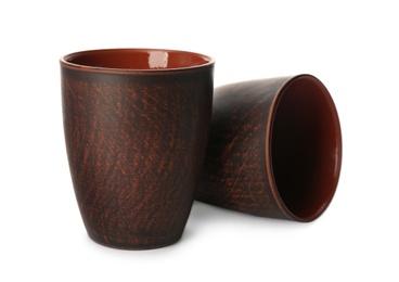 Photo of Stylish brown clay cups on white background