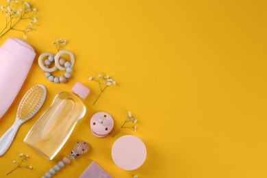 Photo of Flat lay composition with baby care products and accessories on orange background. Space for text
