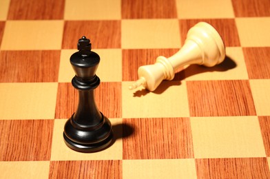 Photo of Wooden chessboard with game pieces, closeup view