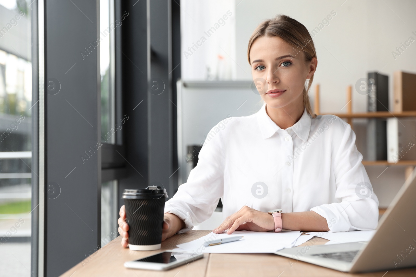 Photo of Female business trainer working with laptop in office