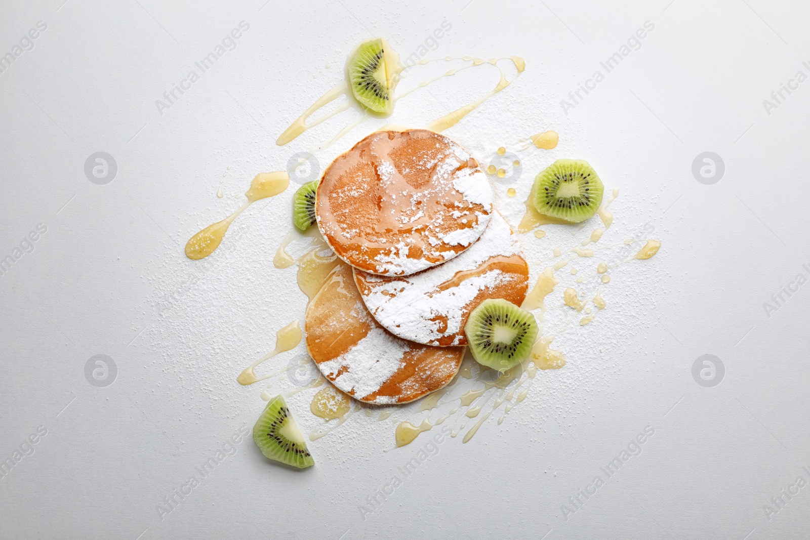 Photo of Flat lay composition with tasty pancakes on light background