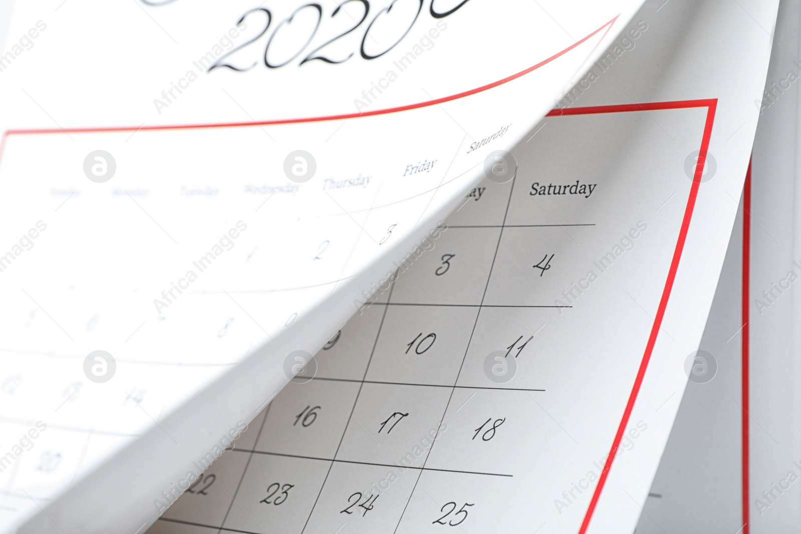 Photo of 2020 paper calendar with turning pages as background, closeup