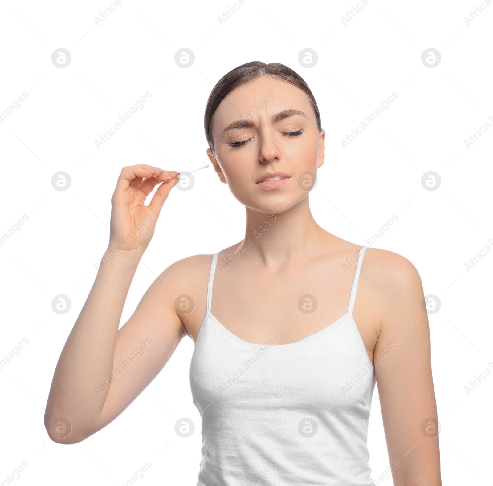 Photo of Young woman cleaning ear with cotton swab on white background