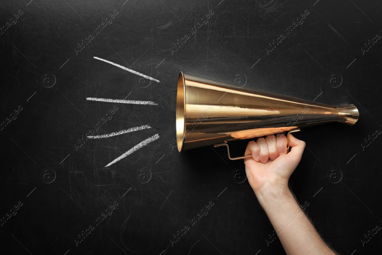 Photo of Man holding retro megaphone near chalkboard