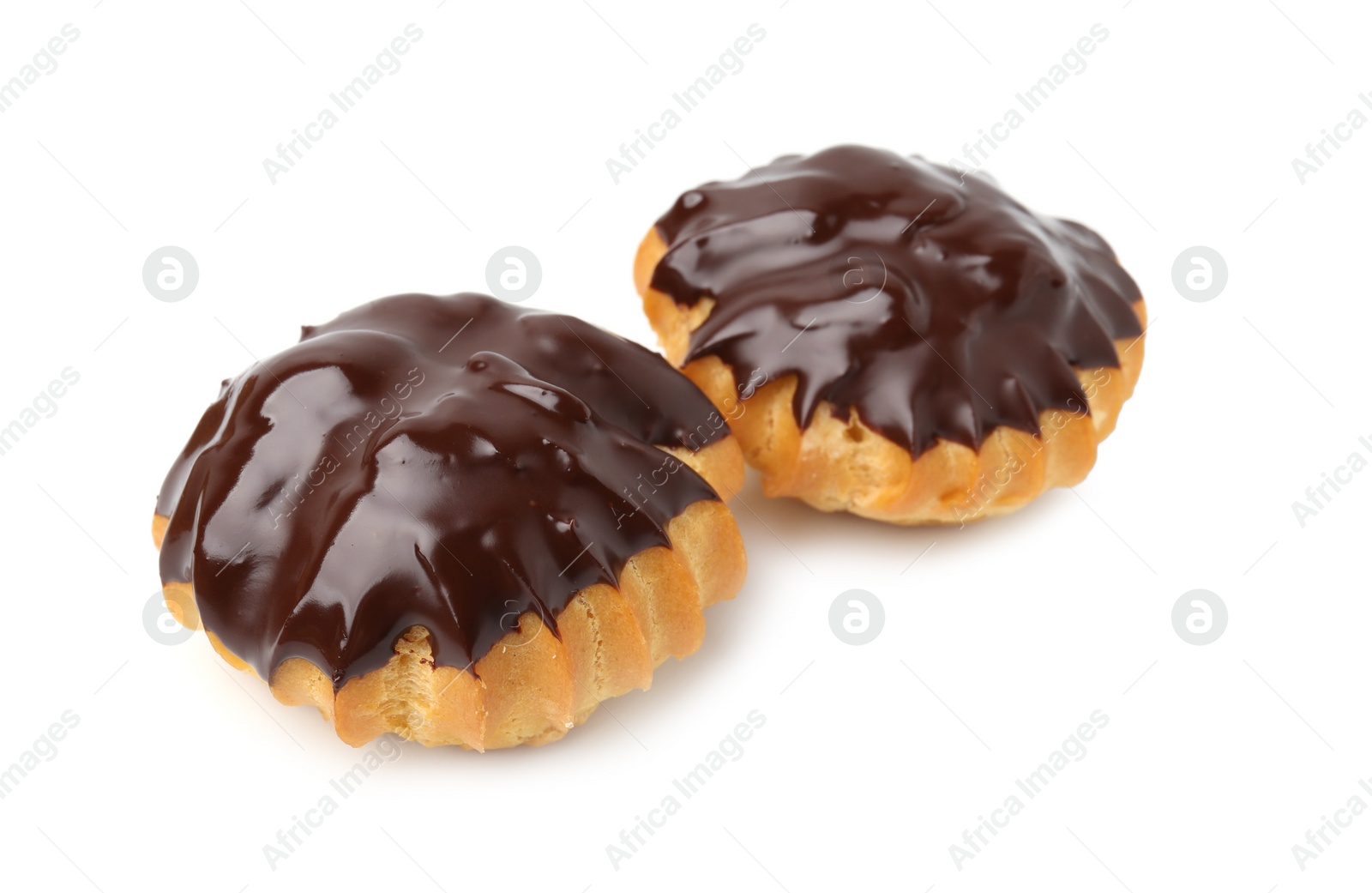 Photo of Delicious profiteroles with chocolate spread isolated on white