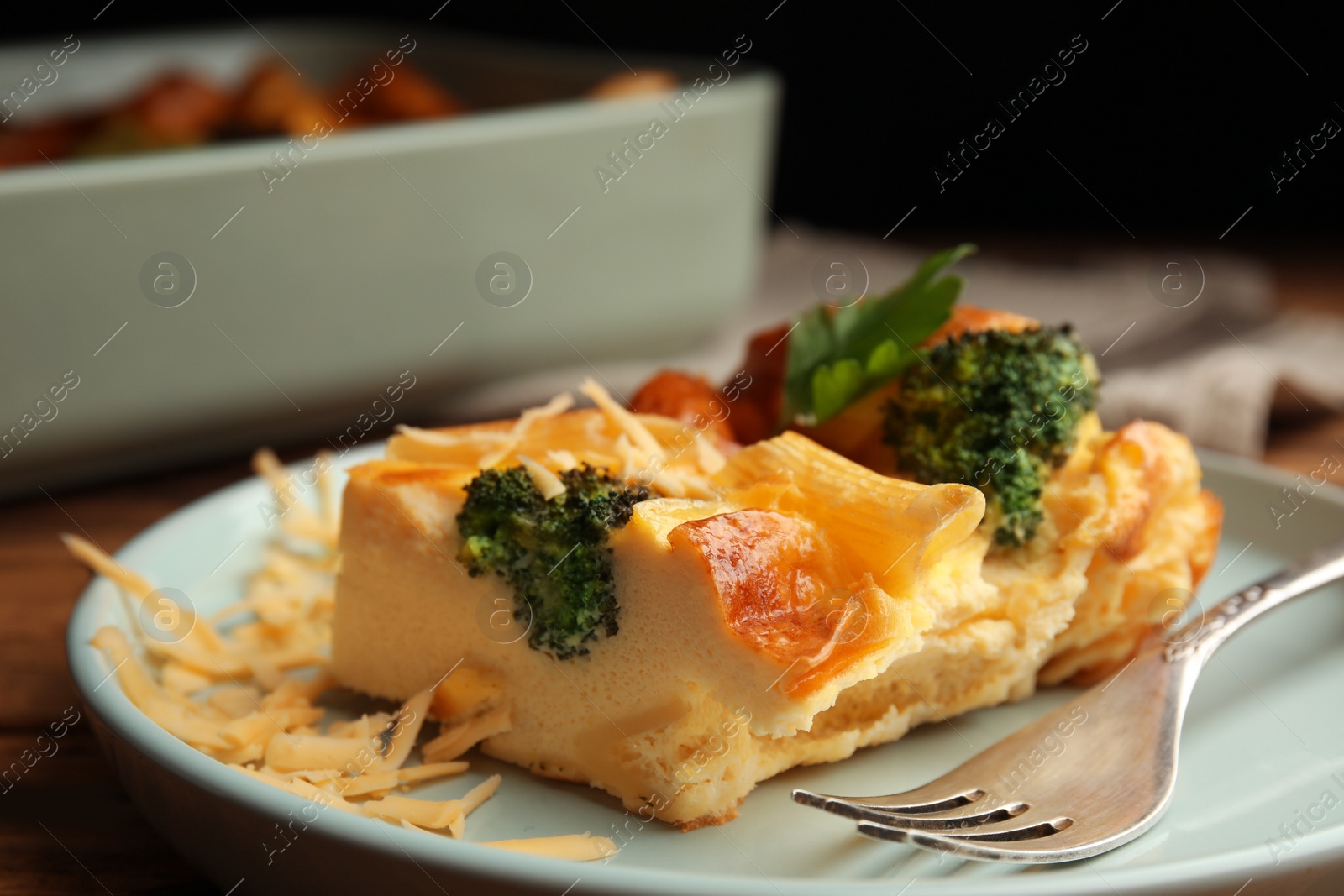 Photo of Tasty broccoli casserole with cheese on plate, closeup