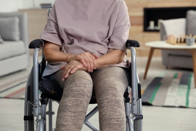 Photo of Handicapped elderly woman at nursing home, closeup. Assisting senior people